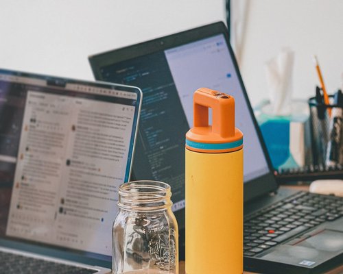 water bottle and notebook on a work desk